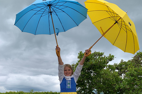 Midsummer girl with a blue and yellow umbrella